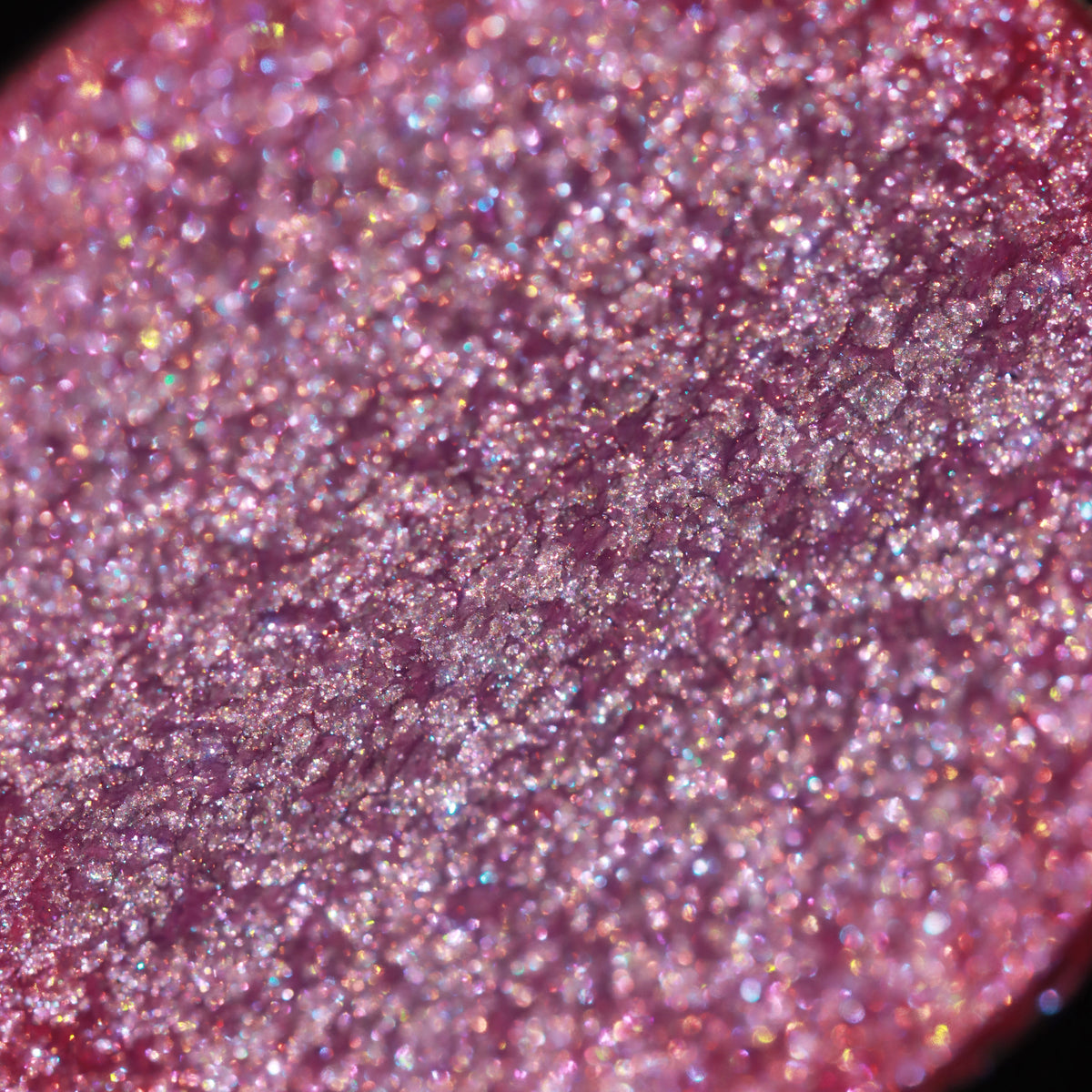 Macro of the pan surface: pink with multicoloured sparkle.