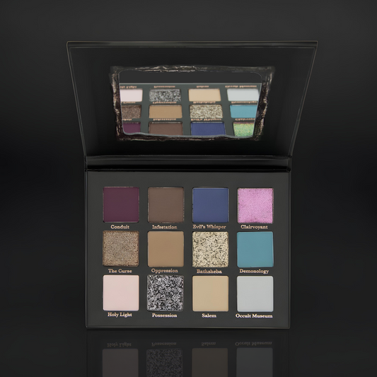 Lethal The Conjuring eyeshadow palette open showing 12 shades in stormy mattes, reflective metallics, and a holochrome