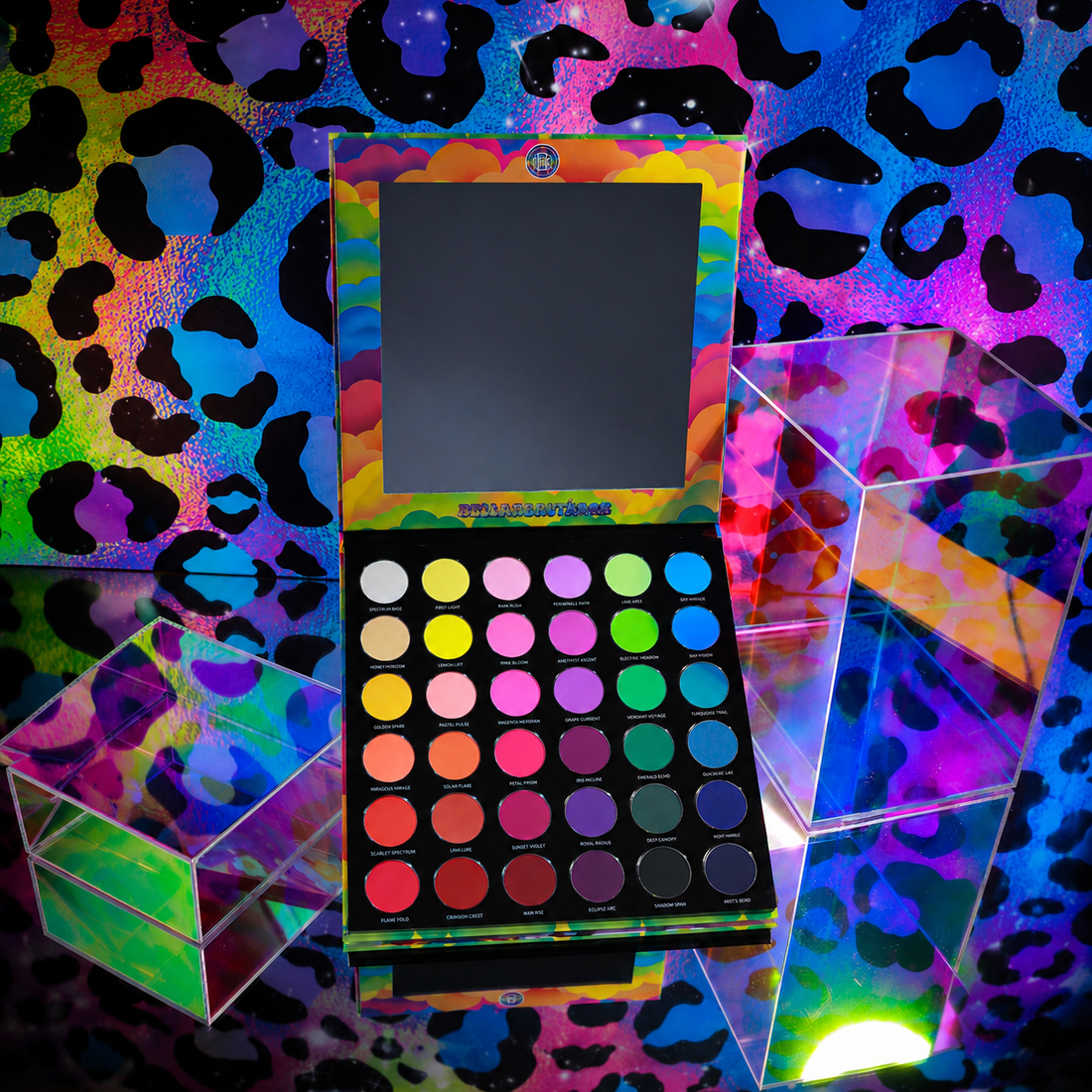 Bellabeautebar Arch of Color eyeshadow palette open, mirror in lid, 36 round matte pans in rainbow rows on a neon leopard print backdrop