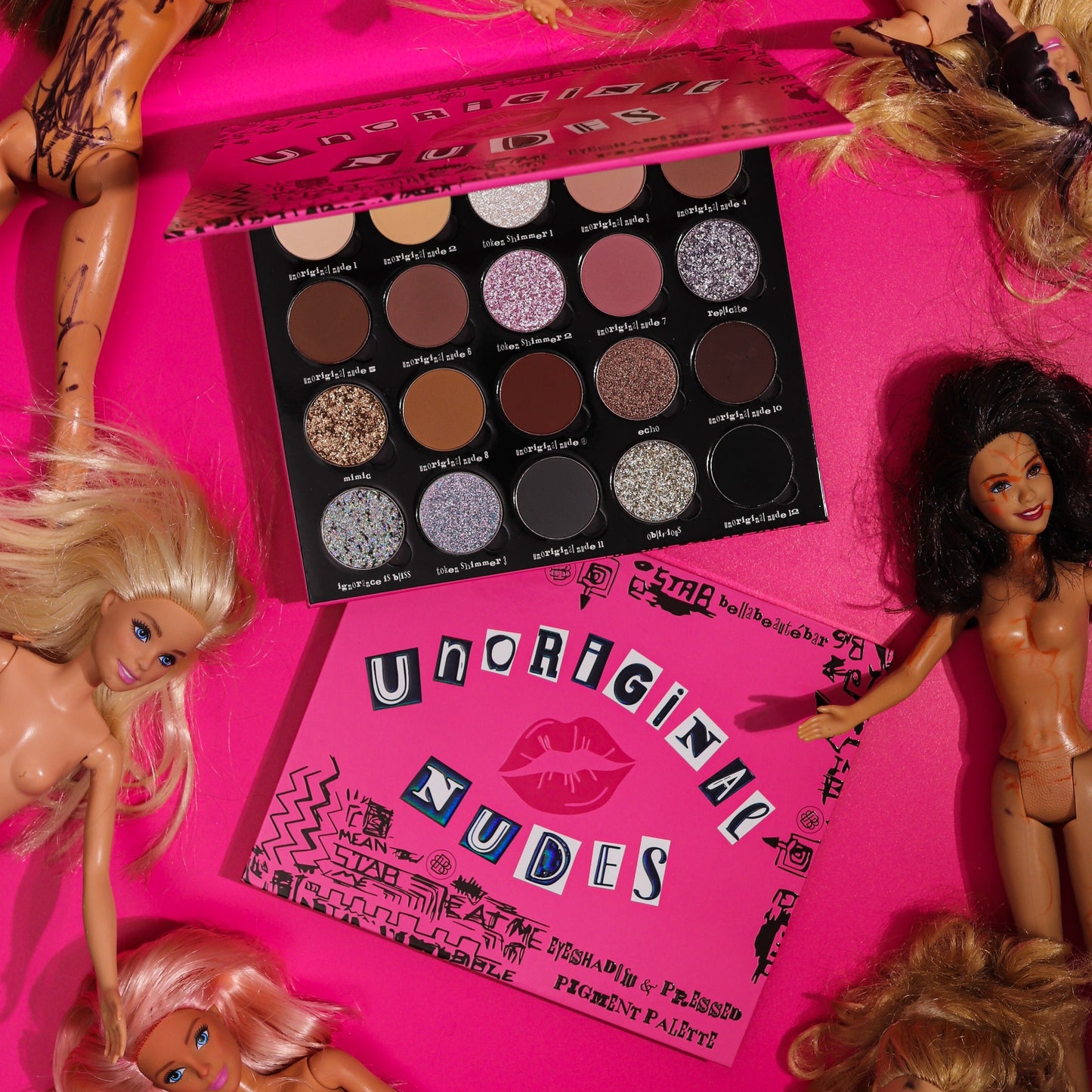 Makeup palette labeled 'Unoriginal Nudes' surrounded by barbie dolls on a pink background