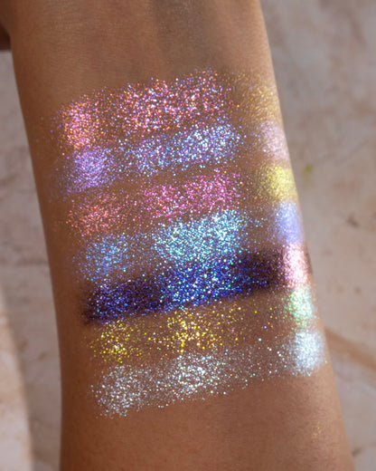 On Cloud 9 shimmer shades swatched, sparkly blue, lilac, and gold-pink shifts on skin