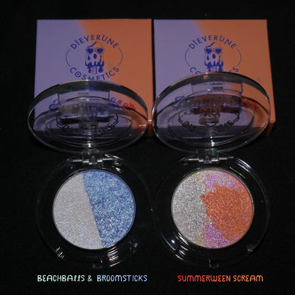 Both compacts and their boxes on black, labelled Beachballs and Broomsticks and Summerween Scream.