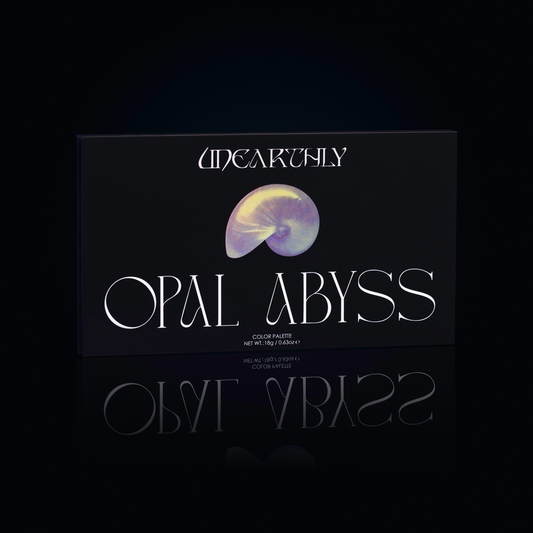 Unearthly Cosmetics Opal Abyss palette closed, black box with iridescent nautilus shell illustration and Opal Abyss lettering