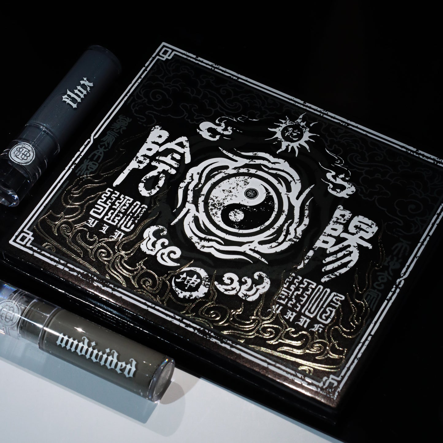 BellaBeauteBar Yin & Yang x Freya86_ff eyeshadow palette cover with gold-embossed Chinese artwork and Yin Yang symbol, alongside two Flux liquid eyeshadow tubes