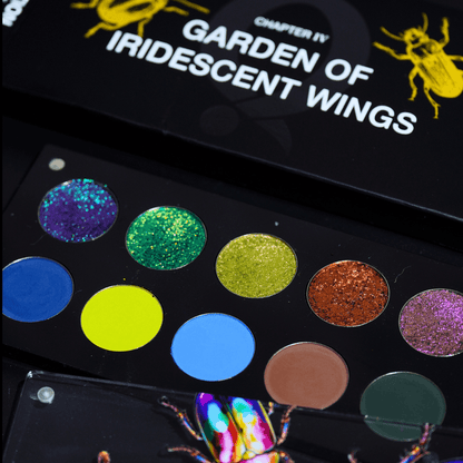 Open palette angled view showing ten pressed pans in two rows, shimmer multichromes on top and matte plus shimmer garden shades below, title visible on lid.