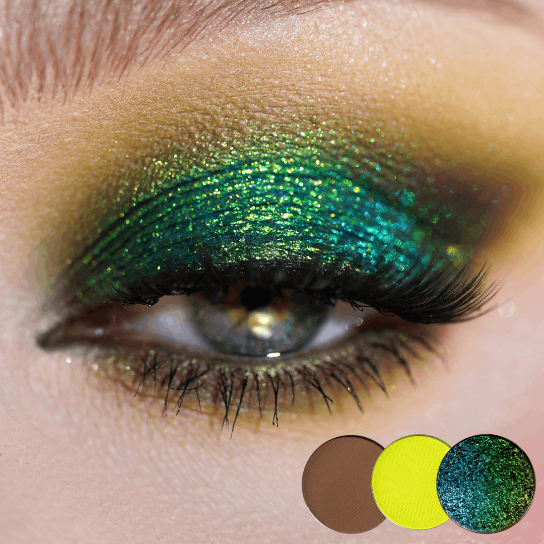 Close-up of a blue eye with teal green shimmer on the lid and chartreuse yellow in the inner corner, three round shade dots below.