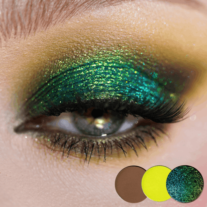 Close-up of a blue eye with teal green shimmer on the lid and chartreuse yellow in the inner corner, three round shade dots below.