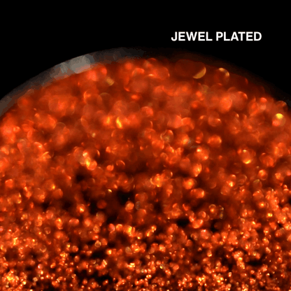 Macro of Jewel Plated pressed pan, fiery orange red multichrome with gold flash, shade name in white type top right.