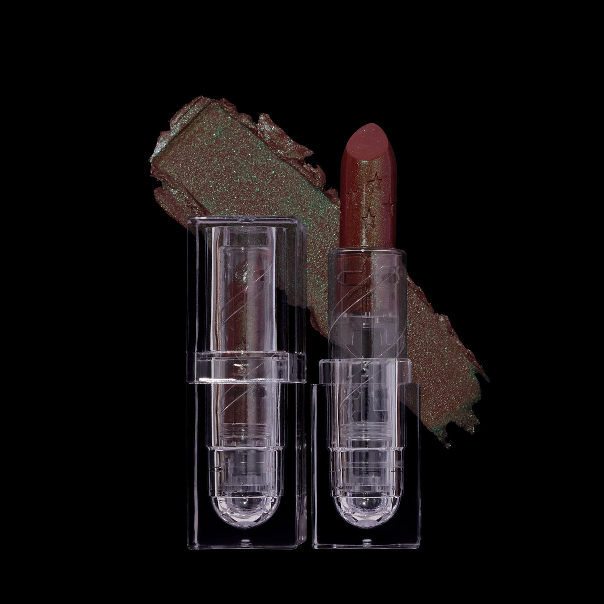 Clear tube and open bullet beside a smear of the balm on black, showing the green shift.