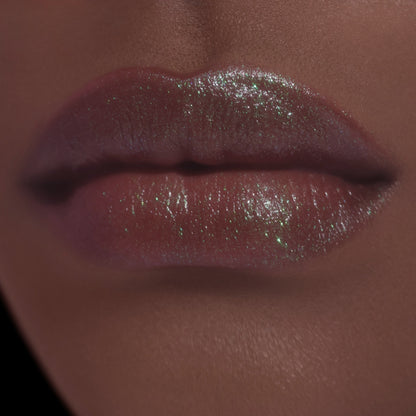 Sheer layer on deeper-skin lips, brown with a green sheen.