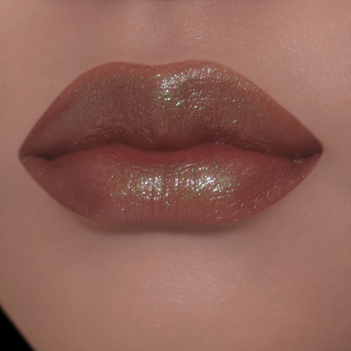 Sheer layer on light-skin lips, brown with a green-gold sheen.