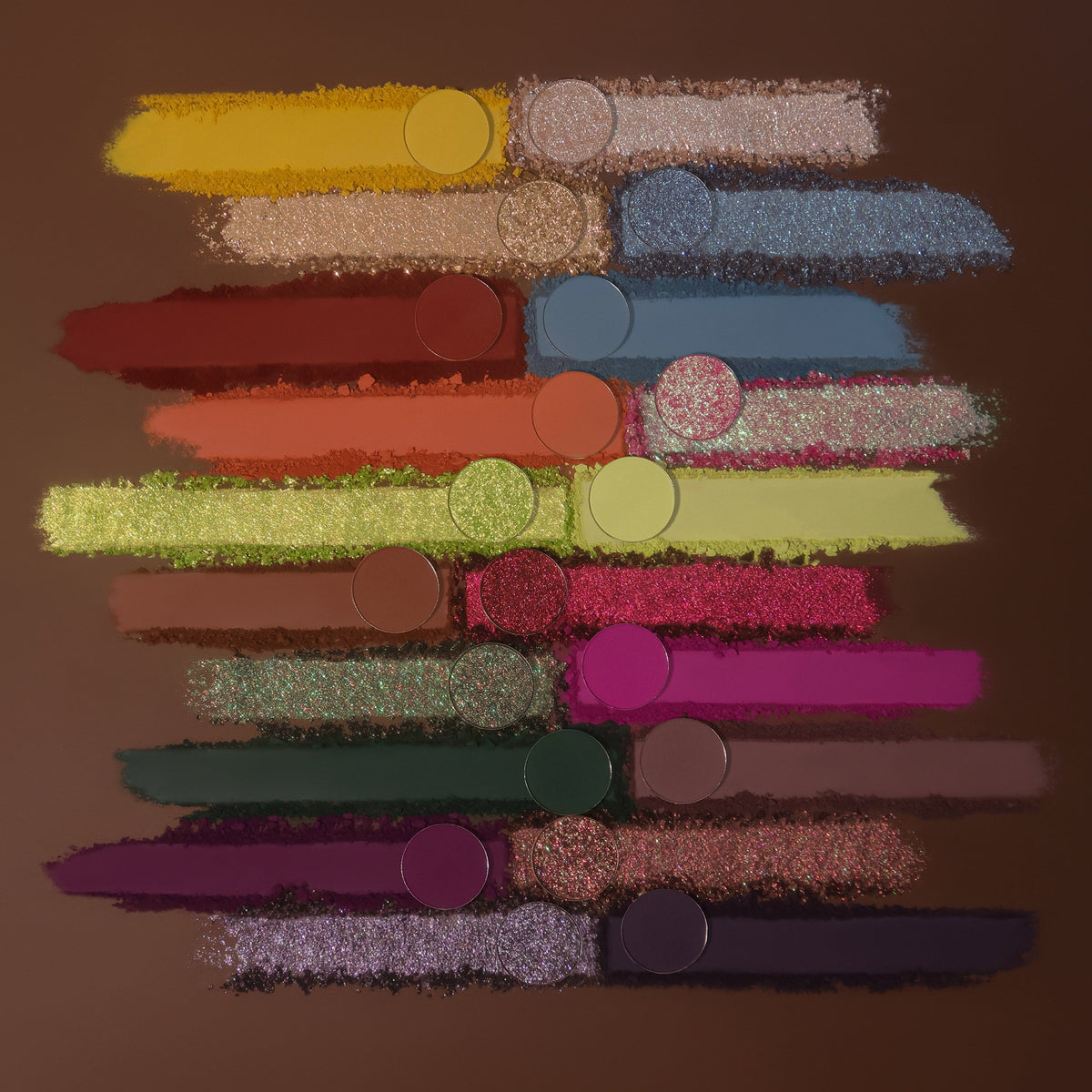 Smears of all 20 shades with their pans on a brown background.