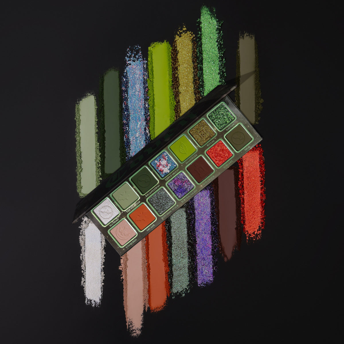 Open Coven palette on black, with a wide swatch smear of every shade fanned out behind it