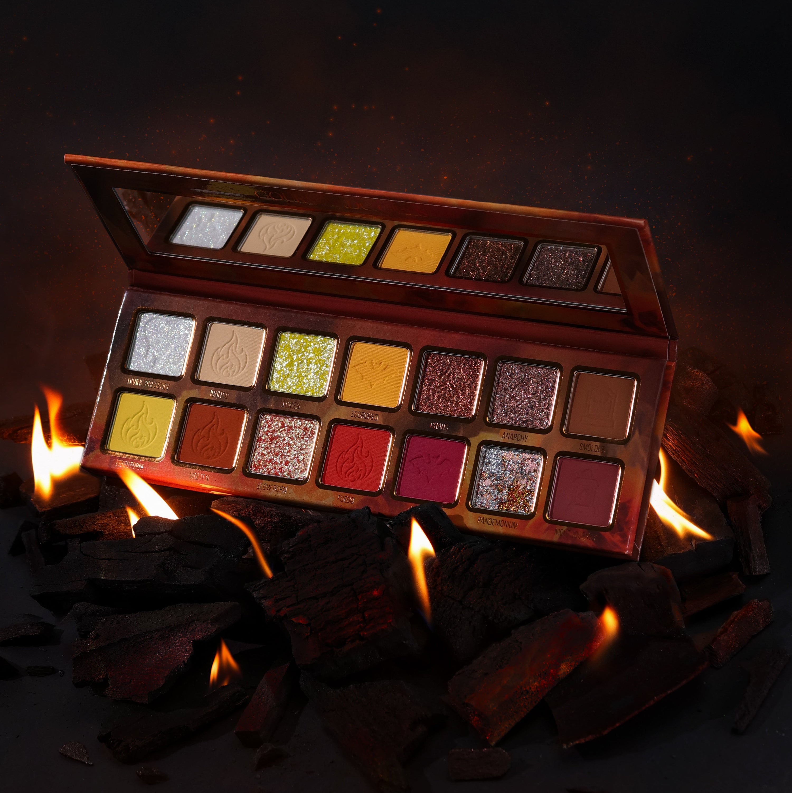 Pandemonium palette open on burning charcoal, pans labelled Divine Presence, Lumen, Scorched, Chaos, Anarchy, Firestorm, Slow Burn, Fuego and Night Journey
