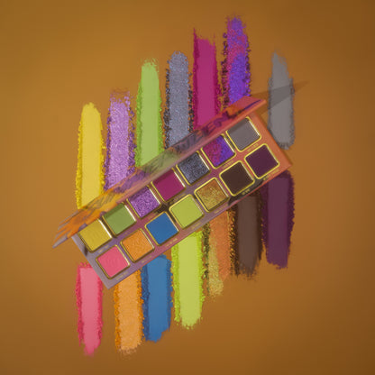 Summerween palette tilted over powder swatch streaks of yellow, purple, green, blue, pink, and copper on a mustard background