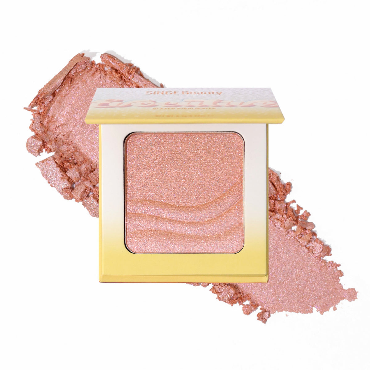 Singe Beauty Evocative glazed highlighter in Mellow Morganite, a golden peach to soft pink, open compact with a wave-embossed pan over a crushed swatch