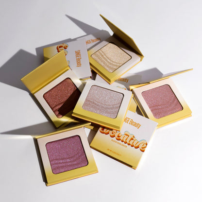 All five Evocative glazed highlighters open and closed in yellow and white compacts, scattered on white with two retro-lettered boxes