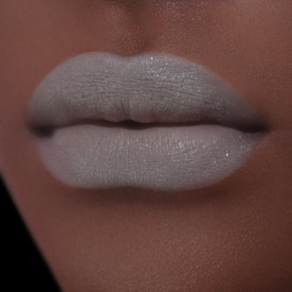 BellaBeauteBar Velvet Veil lip mud in Undivided worn on lips - muted grey green matte finish on deeper skin tone