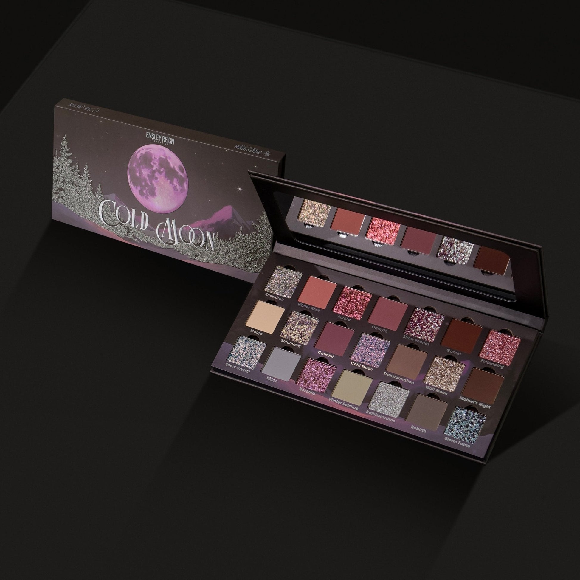Cold Moon palette angled open next to its closed box on dark background, showing the full 21-shade layout across three rows