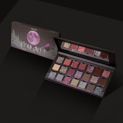 Cold Moon palette angled open next to its closed box on dark background, showing the full 21-shade layout across three rows