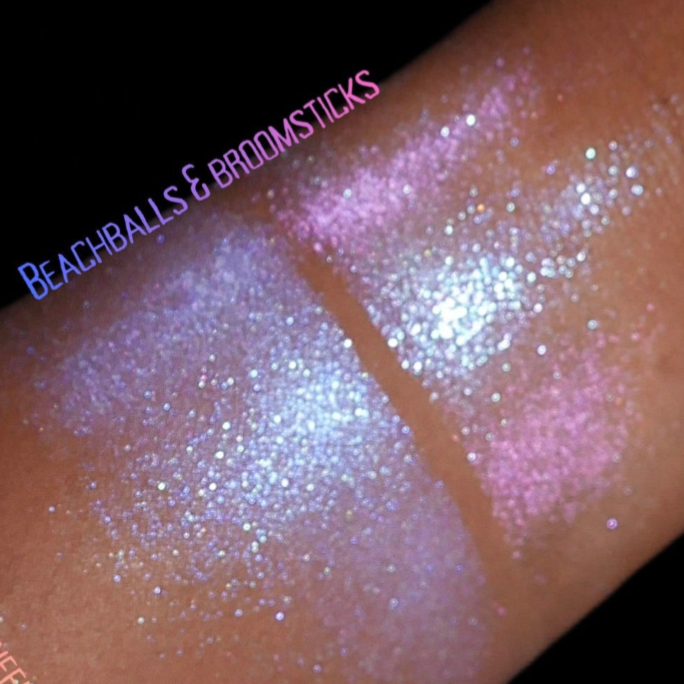 Two Beachballs and Broomsticks swatches on deep skin, the smoother lavender glow next to the pink sparkle.