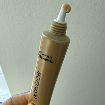 Close-up of the precision applicator tip with a bead of pale gold shimmer base on the threaded gold tube