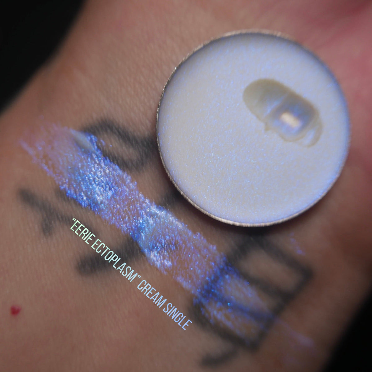 Eerie Ectoplasm arm swatch on light skin beside the pan, labelled