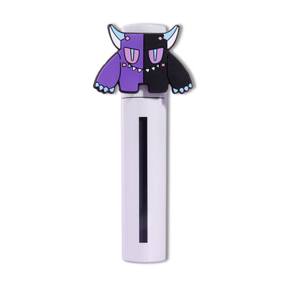 Spite lip milk tube capped with the purple Gloom mascot topper, black product visible through the window.