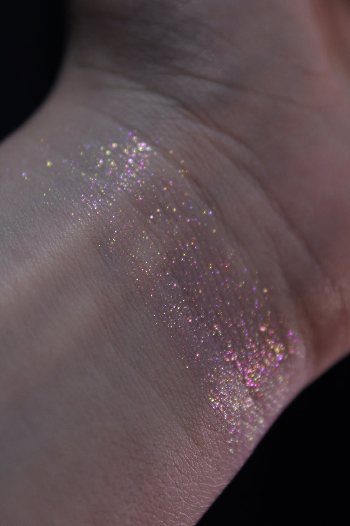 Sheer swatch on the wrist, showing the multicoloured sparkle.
