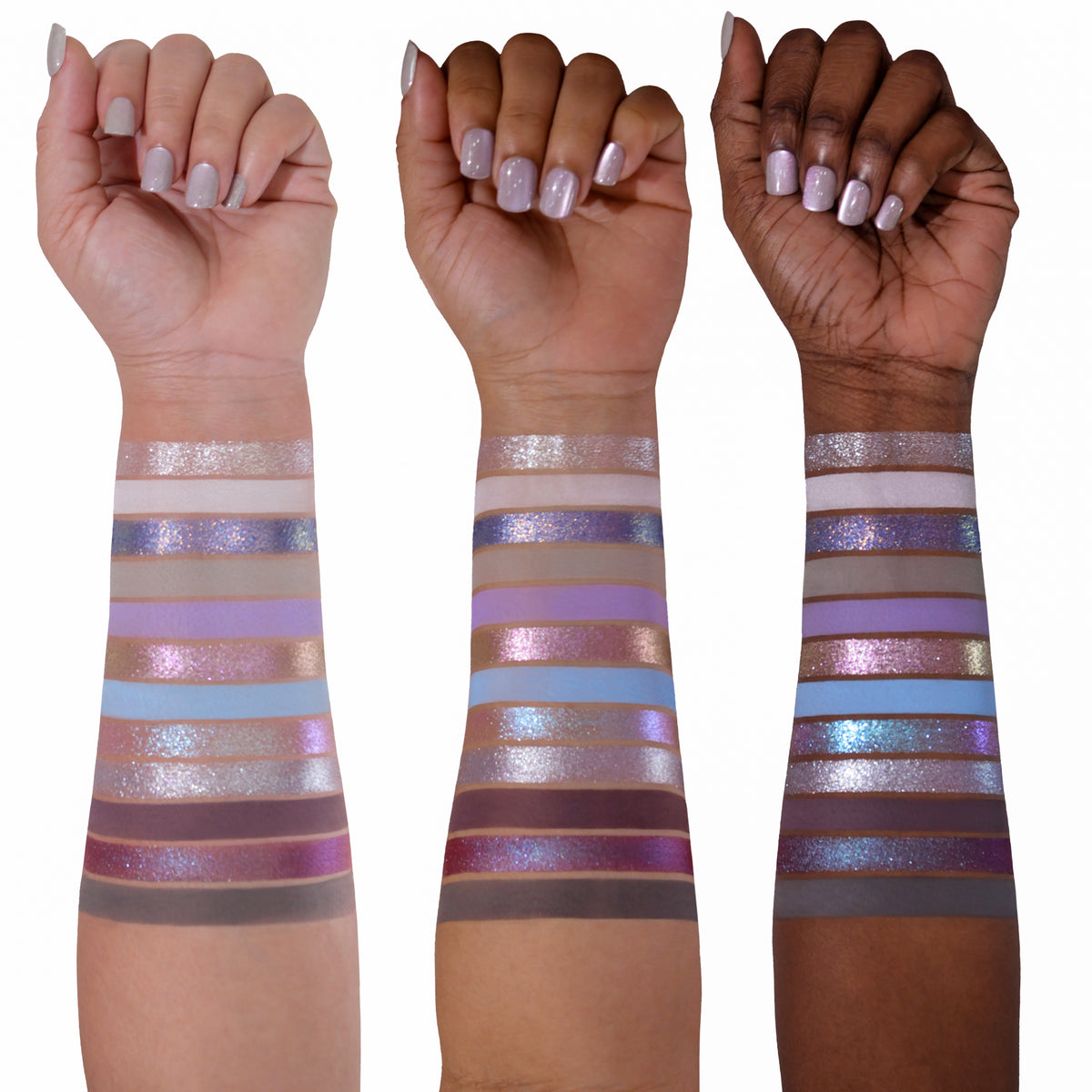 All 12 Into the Mist shades swatched on three skin tones from light to deep: silver and lilac sparkles, lavender, sky blue, plum and charcoal