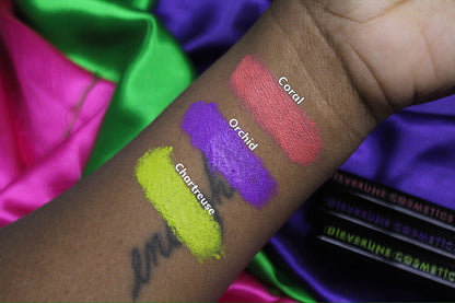 Arm swatches on deep skin against bright satin, labelled Coral, Orchid and Chartreuse.