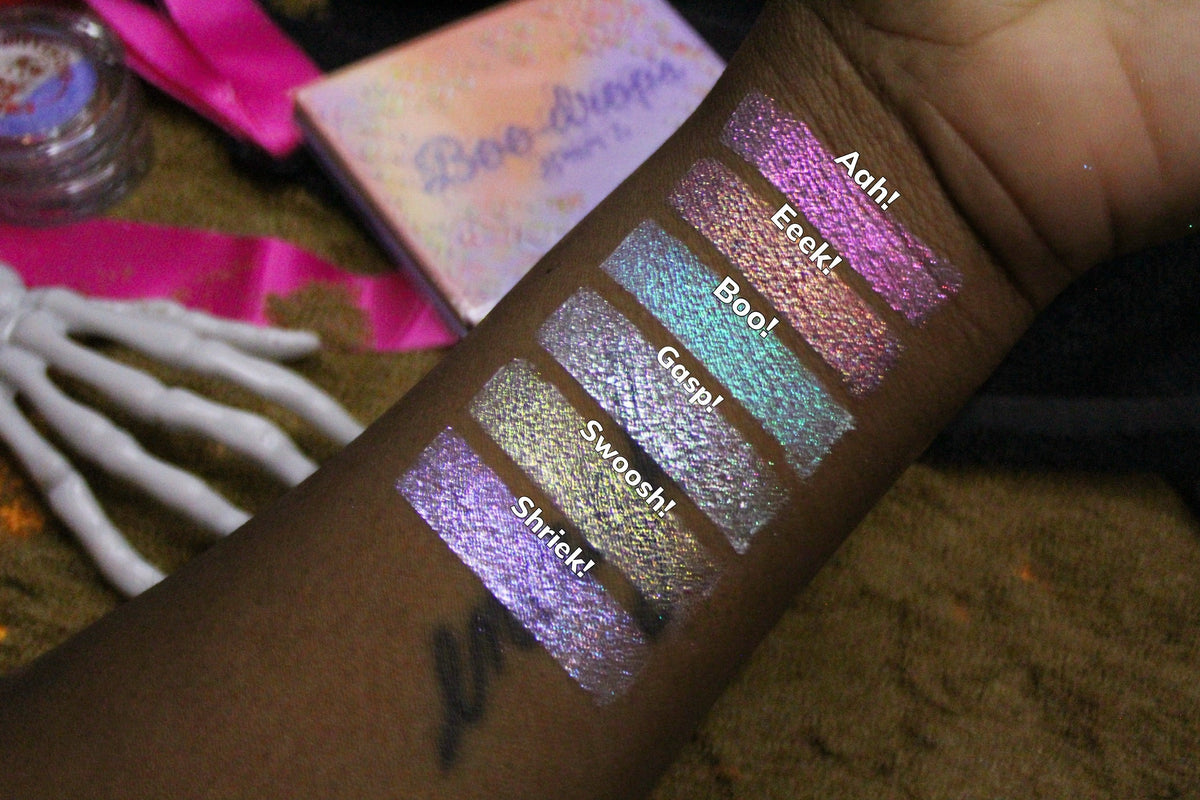 Six labelled arm swatches on deep skin with the closed palette and a skeleton hand prop, running Aah! at the top to Shriek! at the bottom.