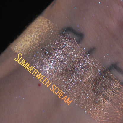 Summerween Scream swatched on light skin against black, gold running into warm copper sparkle.