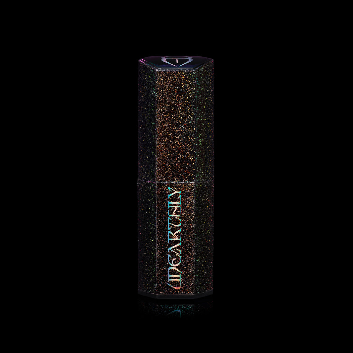 Closed Menacing Cream lipstick in a black hexagonal tube with multicoloured sparkle flecks and an iridescent Unearthly logo