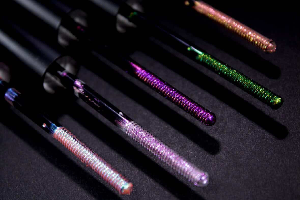 Five Sparkle Veil applicator wands fanned on a dark surface, one per shade