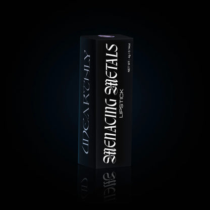 Menacing Metals lipstick carton standing on a black reflective surface, tall matte black box with the shade window on top