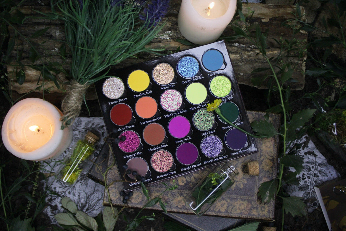 Garden of Spells palette open among candles, a lavender bundle and a potion bottle, shot from above.