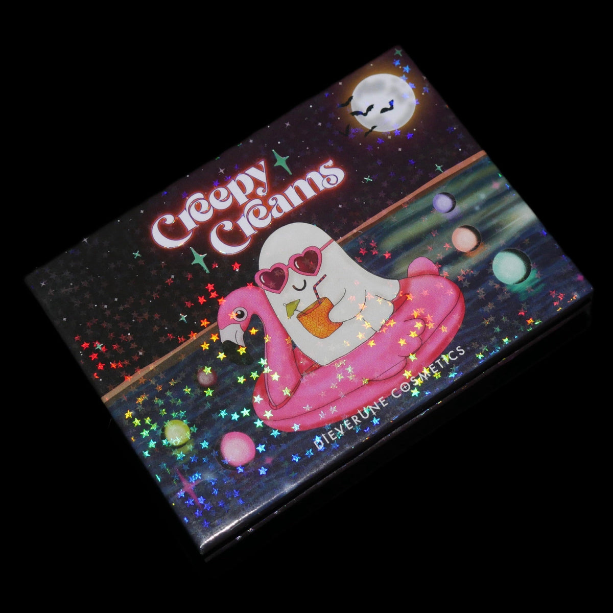 The closed palette angled on black, the holographic star-flecked lid catching the light.