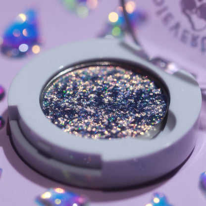 Hexed Holochrome in its open magnetic compact on a lilac backdrop