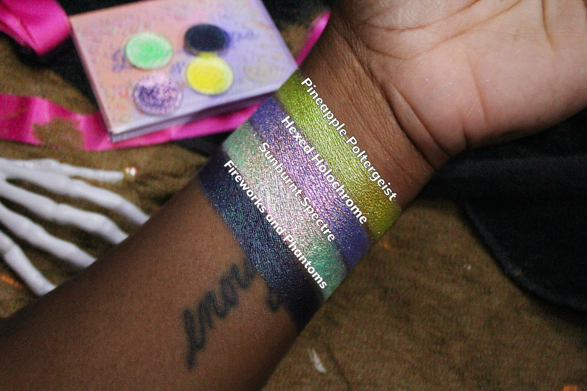All four Summerween singles swatched on deep skin beside their open compacts