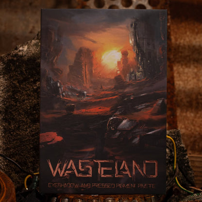 Wasteland palette cover on rusted metal, painted ruined city at sunset, wasteland lettering over the eyeshadow and pressed pigment palette line.