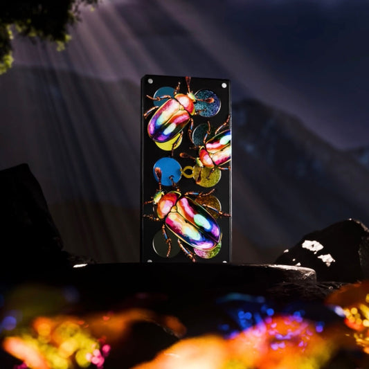 Question Beauty Garden of Iridescent Wings palette closed, lid art of three iridescent scarab beetles on black, dark mountain scene backdrop.