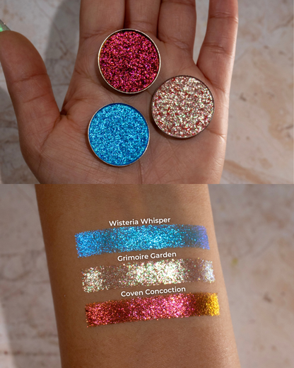 All three pans in a palm above labelled swatches on medium skin.