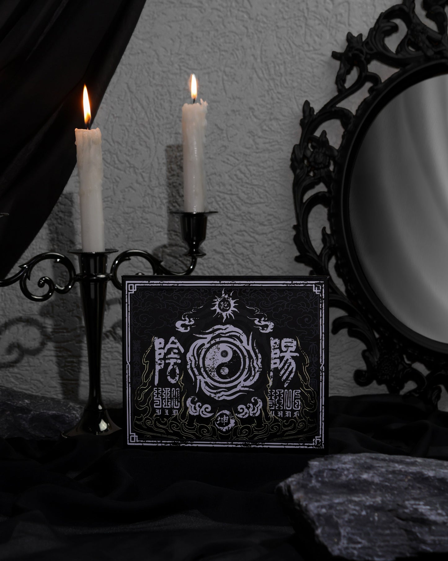 BellaBeauteBar Yin & Yang x Freya86_ff palette cover propped up with black candelabra and ornate mirror in a dark gothic setting