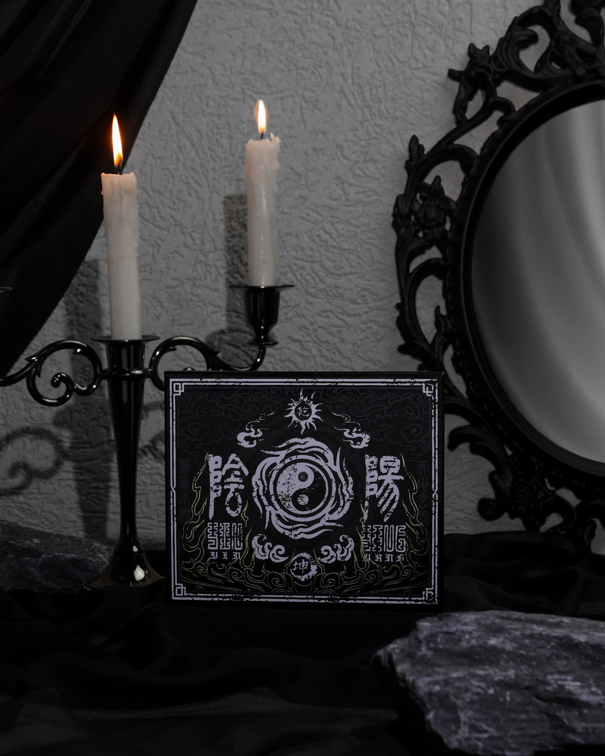 BellaBeauteBar Yin & Yang x Freya86_ff palette cover propped up with black candelabra and ornate mirror in a dark gothic setting