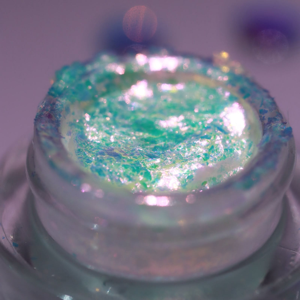 Dieverune Summerween flakie gel in Heat Haze, open jar close-up: electric pink flakes shifting to gold and green in a translucent gel