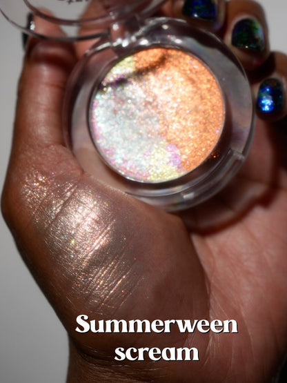 The open Summerween Scream compact held in a palm with a peachy swatch beside it.
