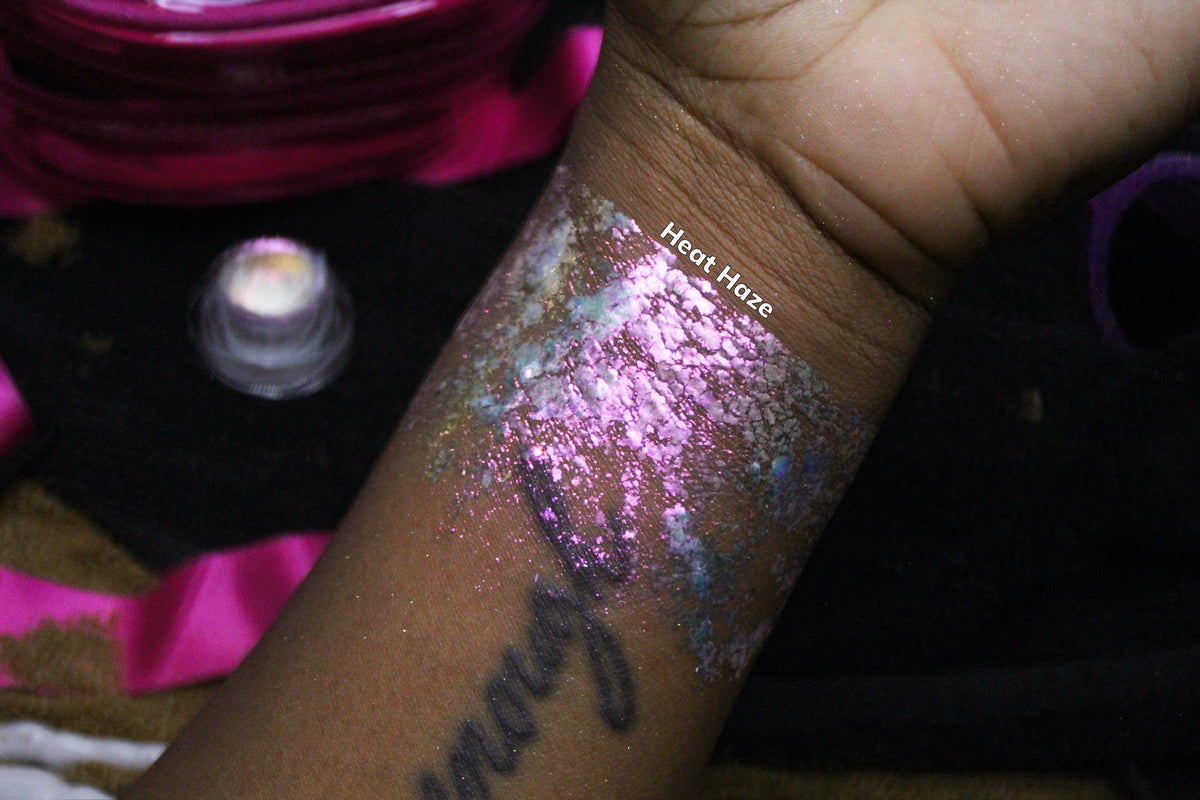 Heat Haze arm swatch on deep skin beside the open jar