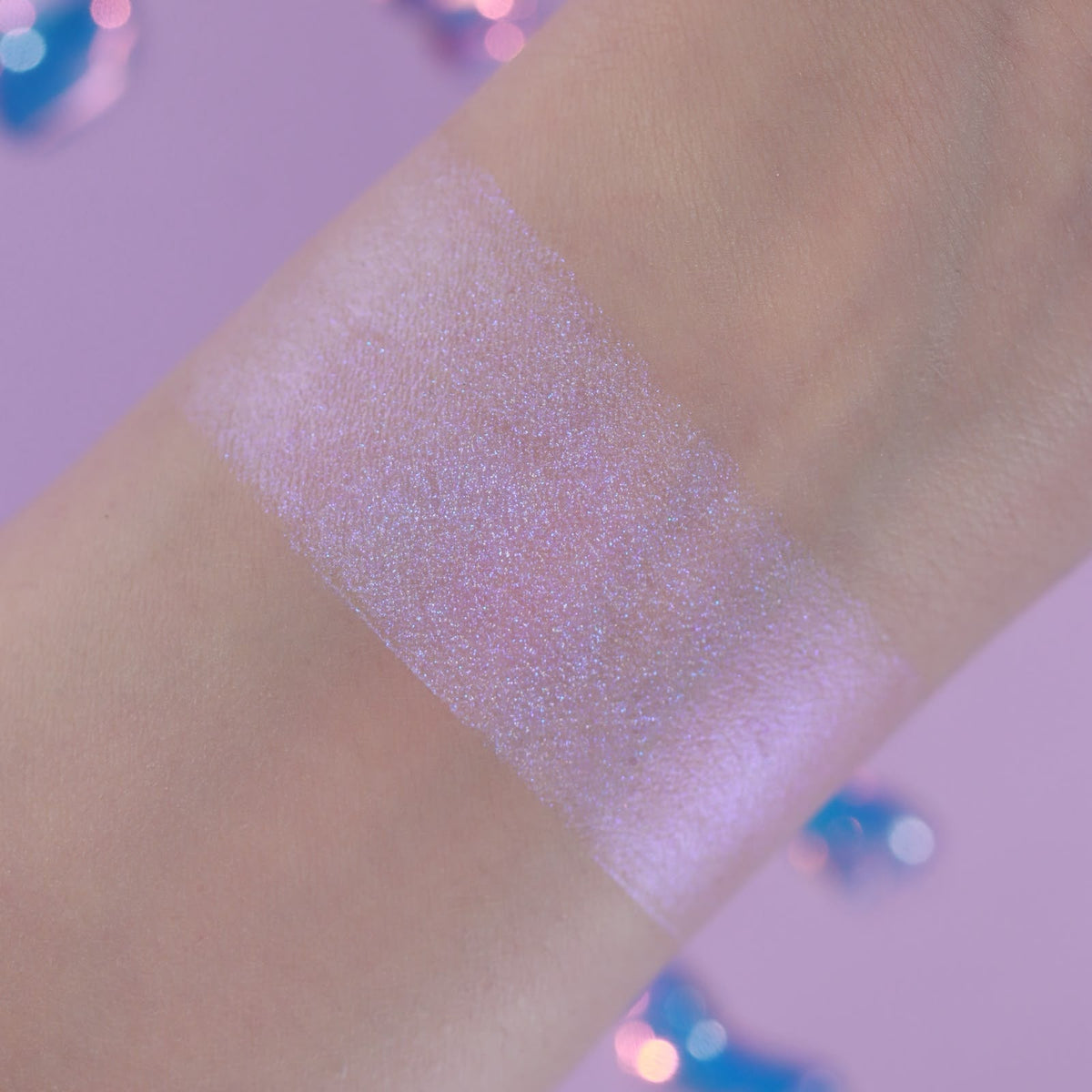 Eerie Ectoplasm arm swatch on light skin on a lilac backdrop
