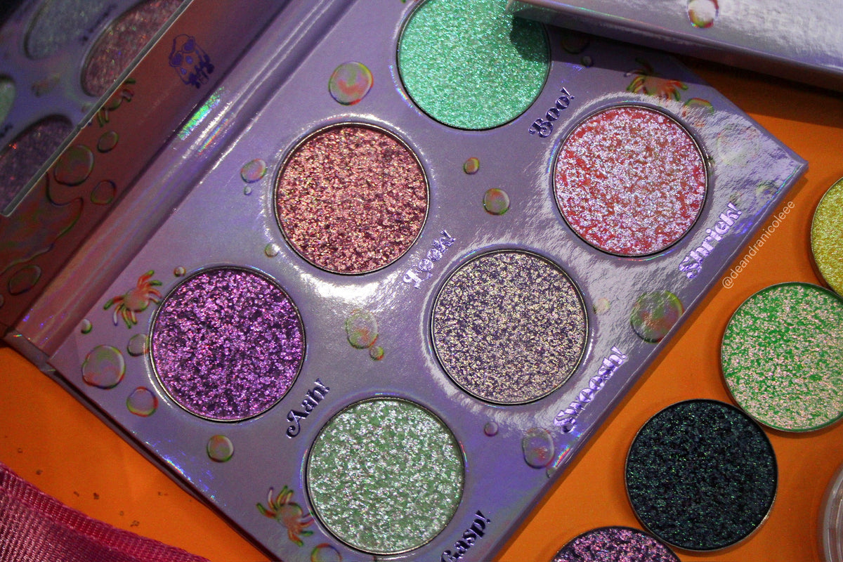 Close crop of the open Boodrops pans at an angle beside a second Dieverune palette in an orange case.